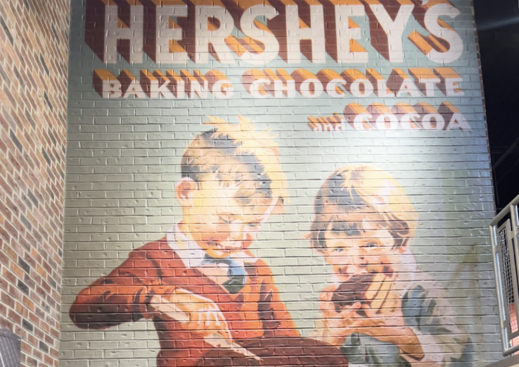 A brick wall with an advertisement for hershey 's baking chocolate.